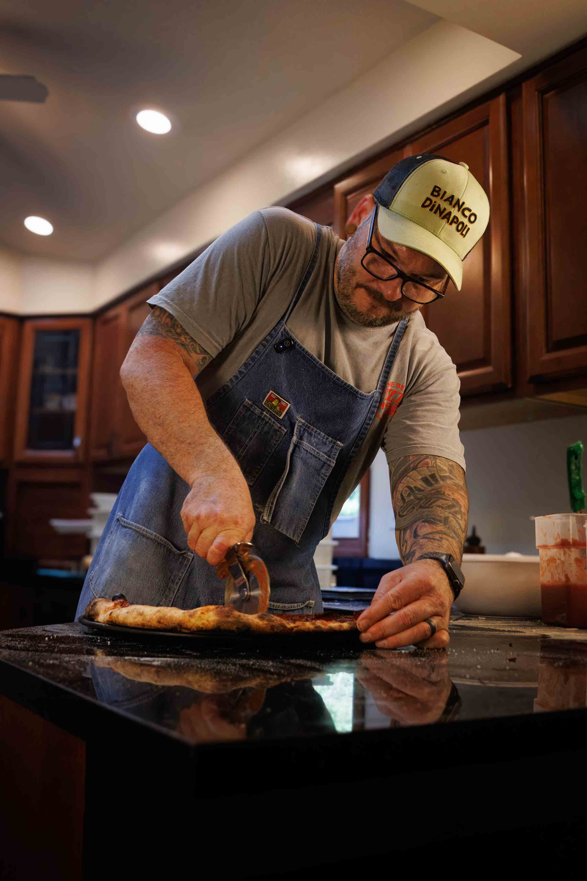 Jesse Wisinski making and evaluating pizza